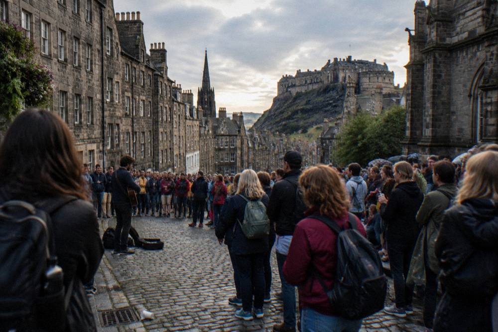 Crowded festival street with temporary venue signage in the Old Town
