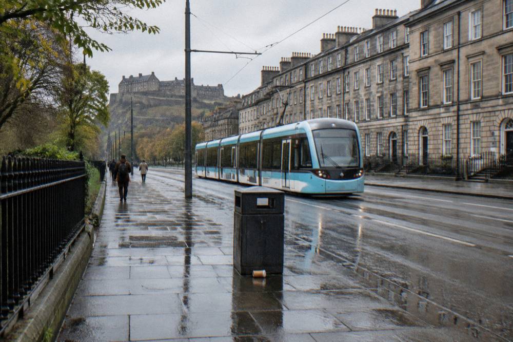 Edinburgh tram travelling along a city street with Georgian buildings on either side