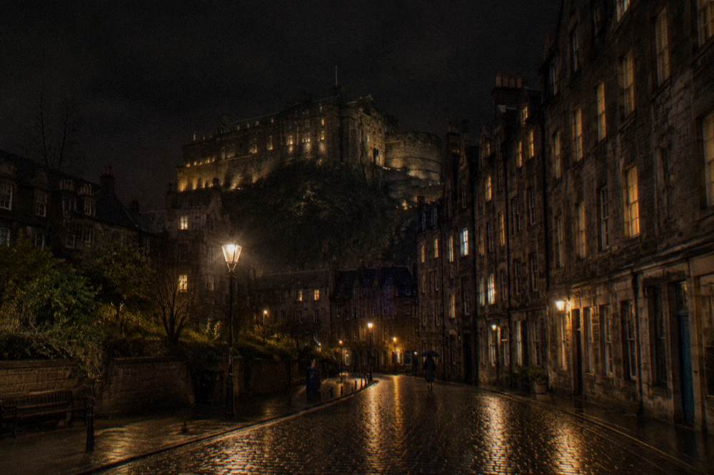 Edinburgh city skyline with lit buildings under a dark evening sky