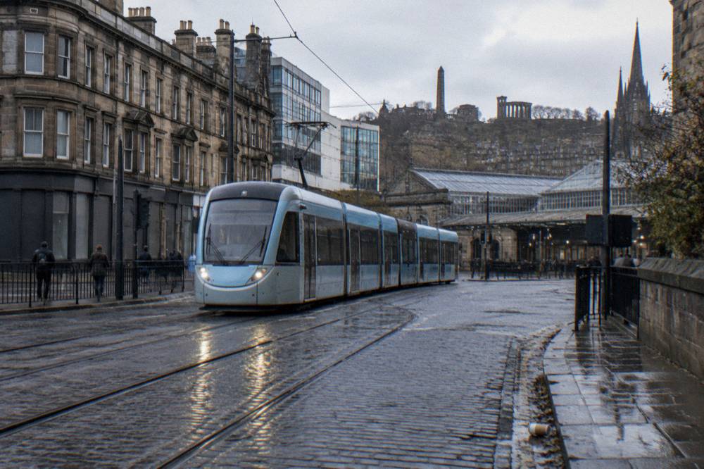 Tram passing modern buildings at the Haymarket junction