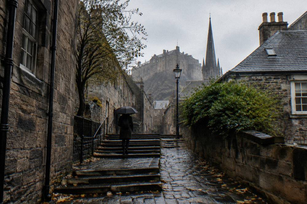 A quiet Edinburgh close with stone steps winding between old buildings