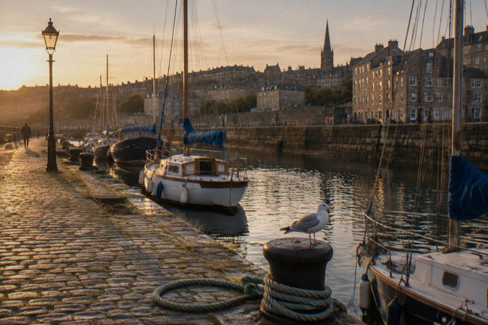 Cobbled quay and moored boats at the Shore in Leith