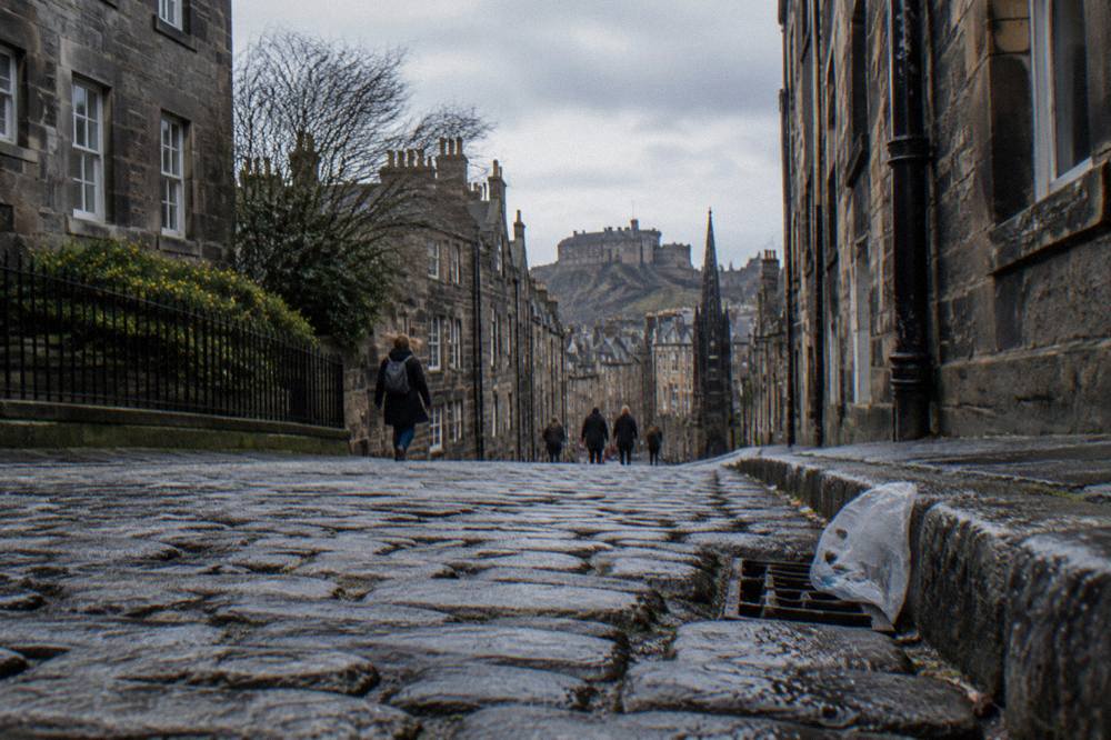 Cobbled Old Town street with tall stone tenements rising on both sides