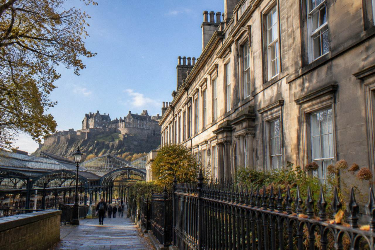 Georgian terrace buildings along a quiet Edinburgh street with stone facades and chimneys