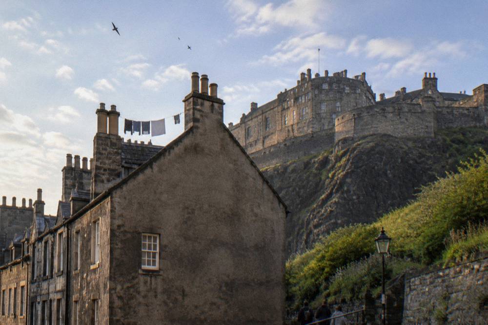 View of Edinburgh Castle from a Grassmarket street with old stone facades