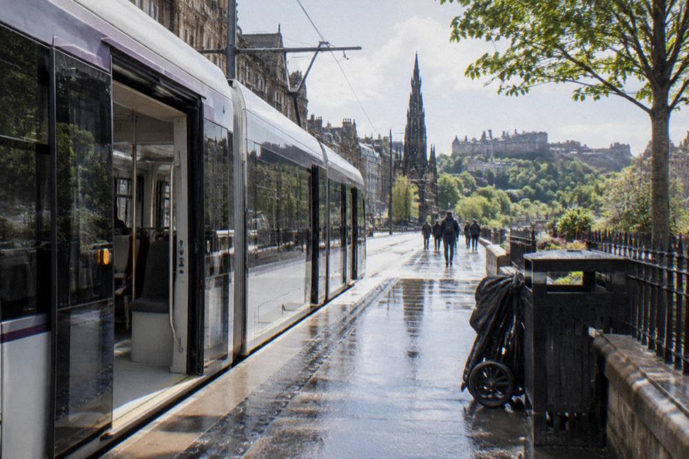 Edinburgh tram stopping at a city centre platform with wide doors and level boarding