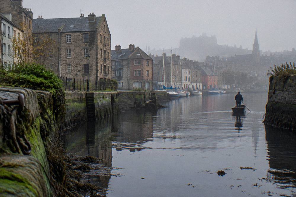 Quayside buildings along The Shore in Leith with the Water of Leith in the foreground