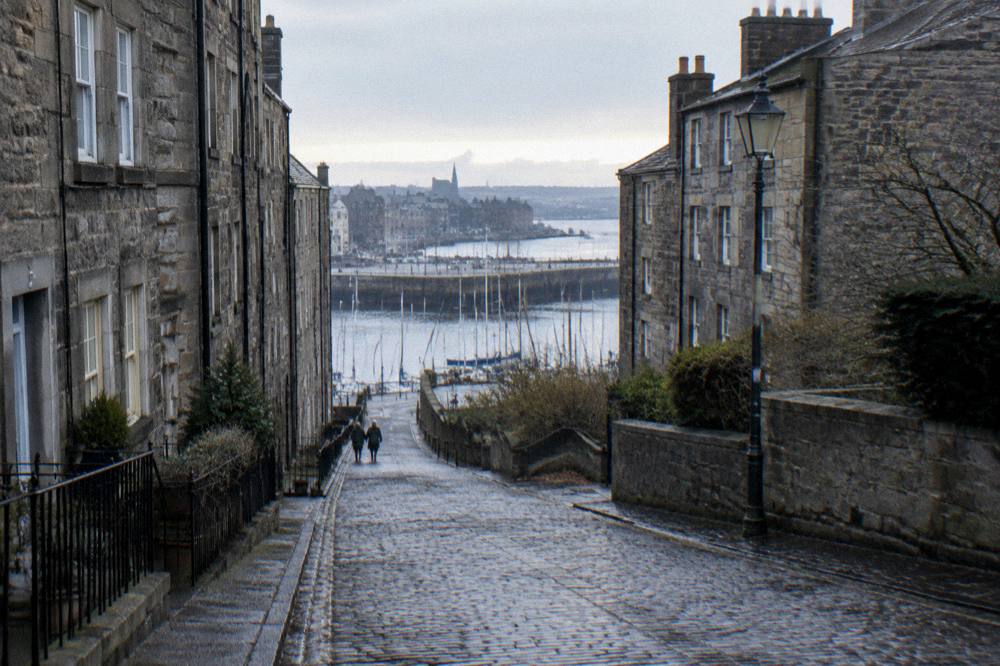 A quiet Leith street in winter with the waterfront visible between buildings