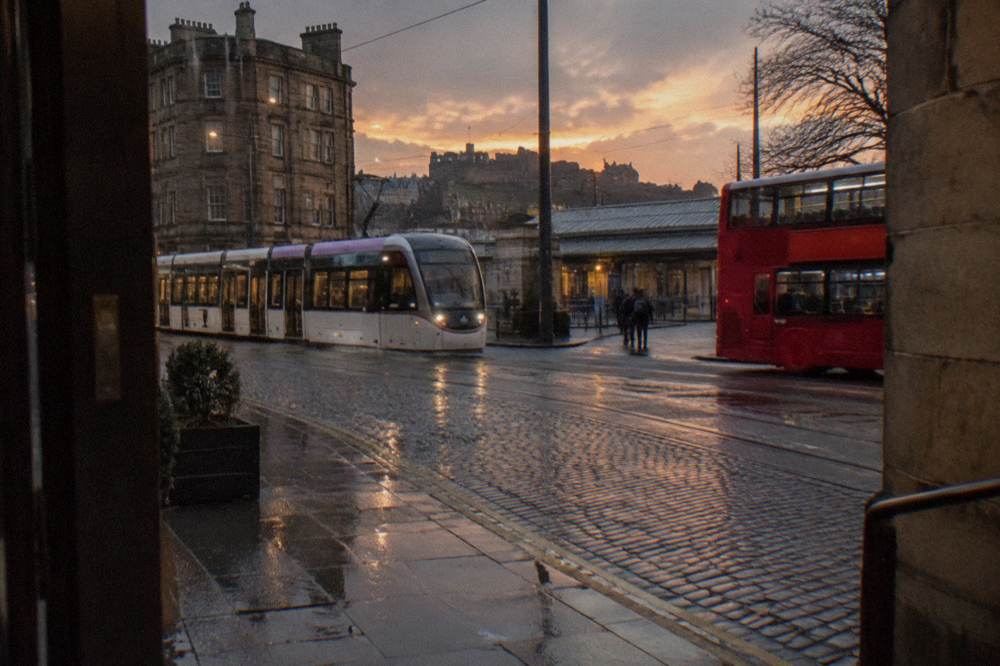 Haymarket station area in Edinburgh with trams and buses at dusk