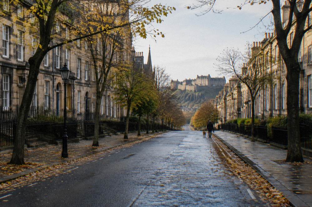 Georgian New Town terrace with autumn trees along a quiet stone street