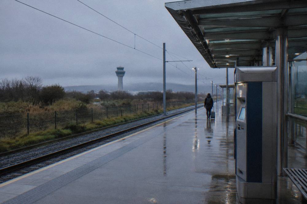 Tram platform at Edinburgh Airport with a ticket machine and quiet concourse
