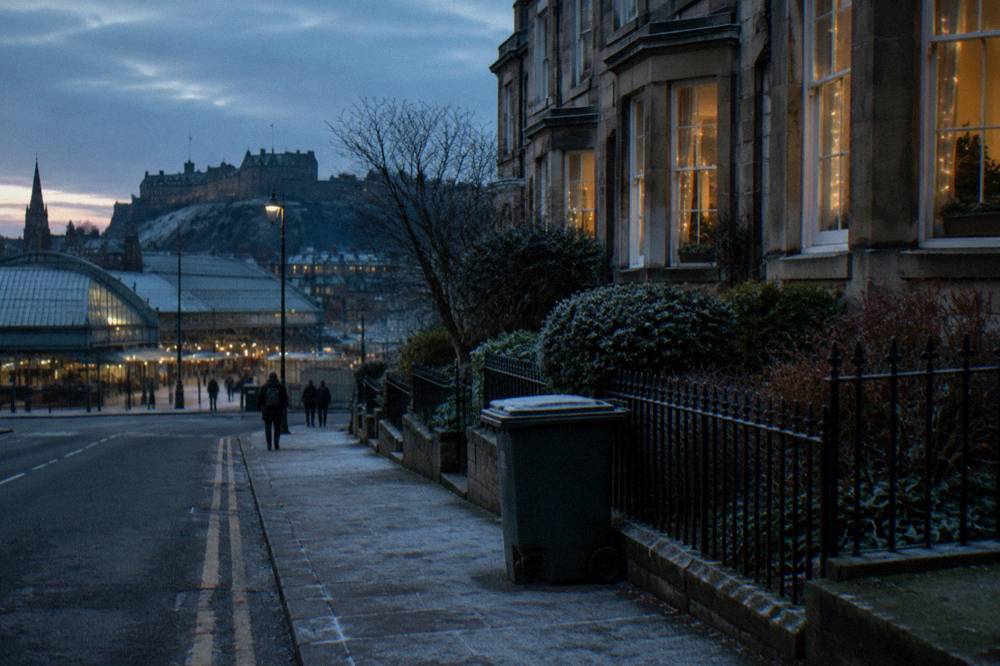 Georgian terraced street with festive window lights in early dusk