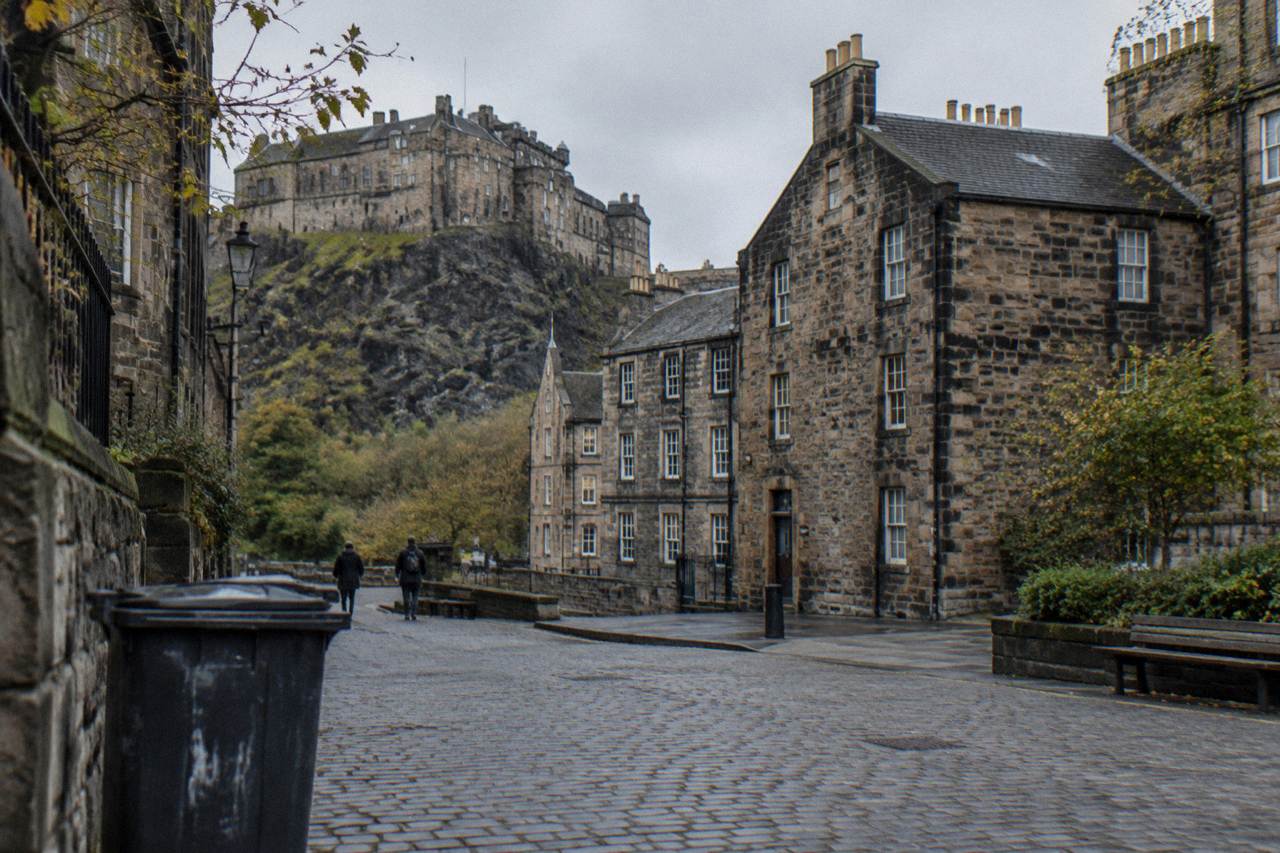 Twin private room with two single beds and a window overlooking old stone buildings