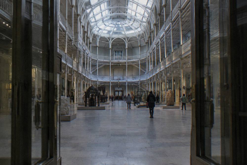 Grand Victorian hall of a national museum with balconies and glass roof
